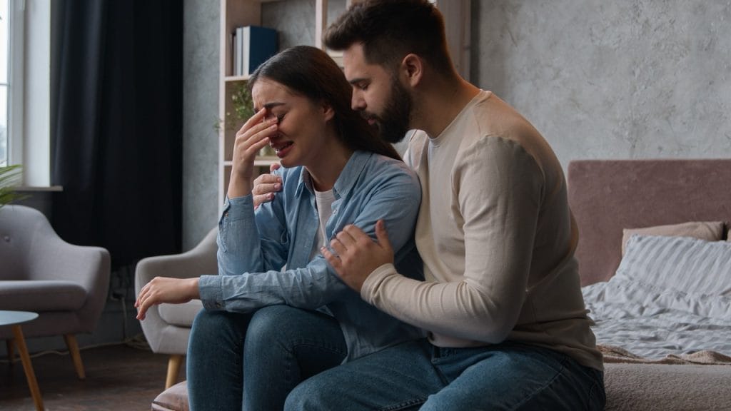 Partner comforting woman during emotional distress